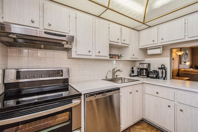 1045 Country Club Dr Unit 304, Margate, FL 33063 - kitchen with range hood, a sink, stainless steel appliances, light countertops, and backsplash