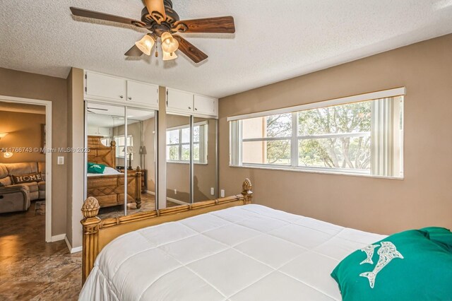1045 Country Club Dr Unit 304, Margate, FL 33063 - bedroom with baseboards, a textured ceiling, and a ceiling fan