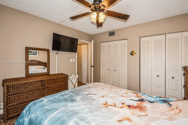 1045 Country Club Dr Unit 304, Margate, FL 33063 - bedroom featuring visible vents, ceiling fan, a textured ceiling, and multiple closets