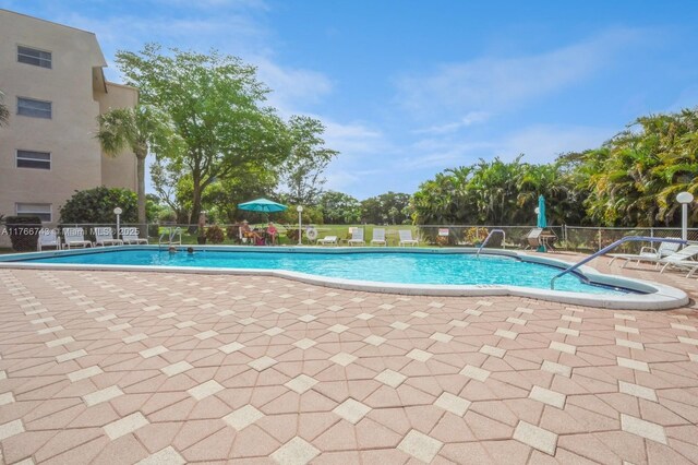 1045 Country Club Dr Unit 304, Margate, FL 33063 - pool featuring a patio area and fence