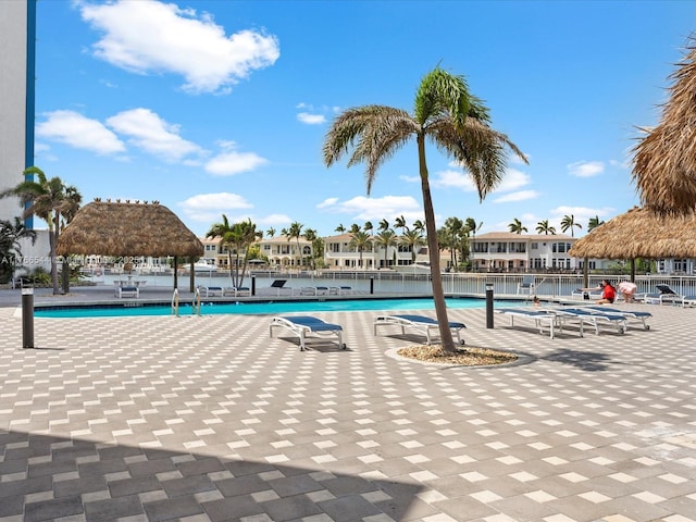 community pool with a gazebo and fence