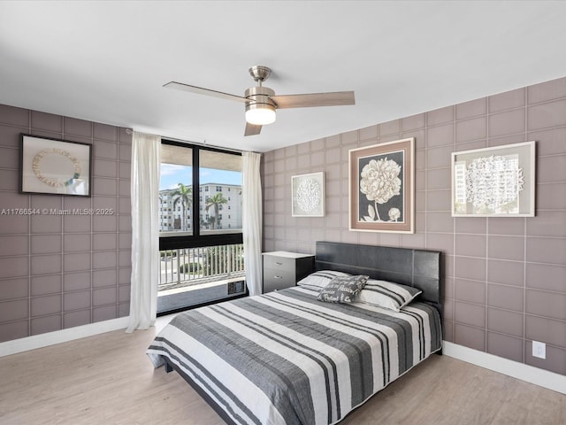 bedroom with baseboards, access to exterior, a ceiling fan, and light wood finished floors