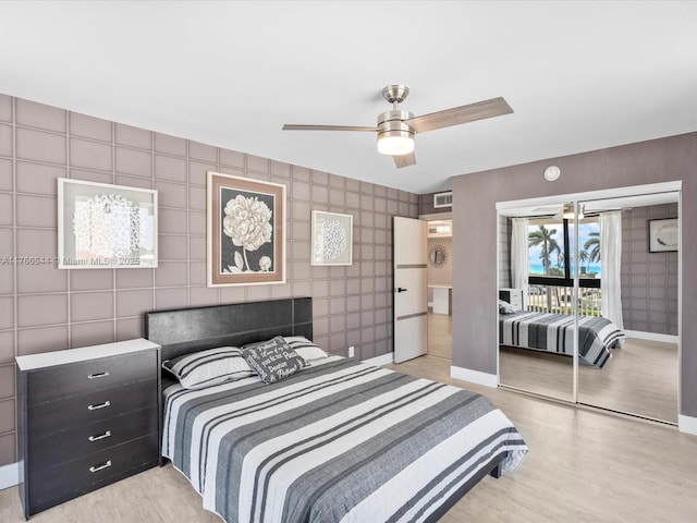 bedroom featuring ceiling fan, baseboards, light wood-style floors, and access to exterior