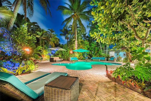 pool with an outdoor hangout area and a patio area