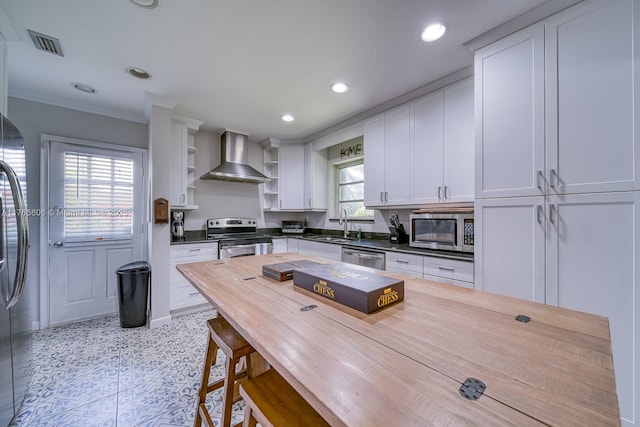 kitchen featuring white cabinets, visible vents, stainless steel appliances, open shelves, and wall chimney range hood