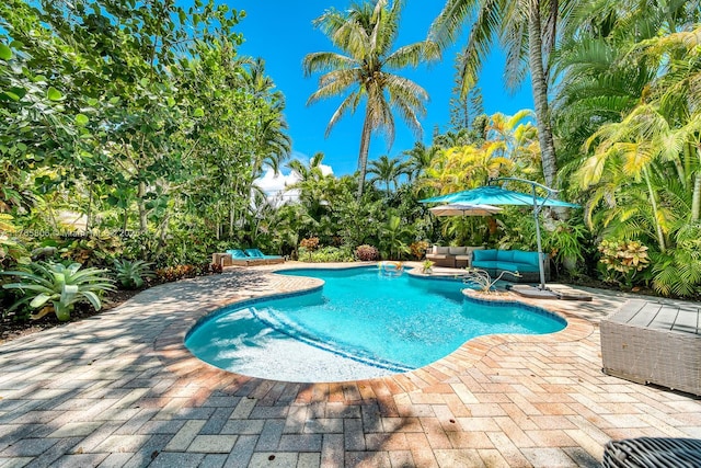 pool featuring an outdoor living space and a patio