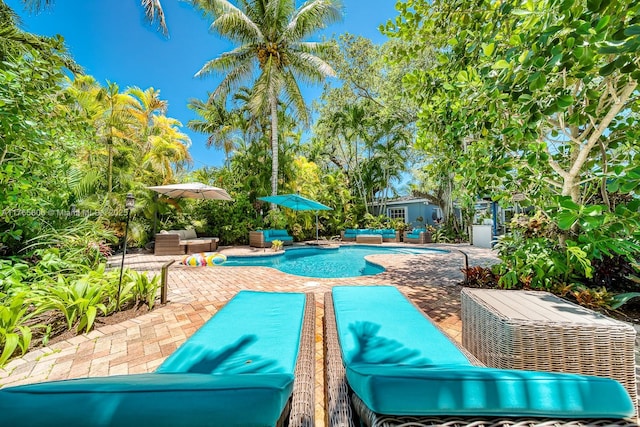 pool featuring outdoor lounge area and a patio area
