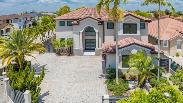 14995 SW 12th Ln, Miami, FL 33194 - mediterranean / spanish-style home featuring a tiled roof, stucco siding, and driveway
