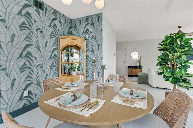 1150 102nd St Unit 501, Bay Harbor Islands, FL 33154 - dining area featuring wallpapered walls and an accent wall