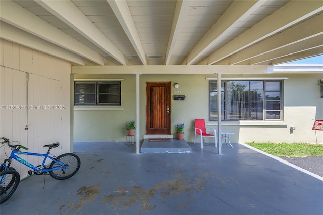 property entrance with stucco siding