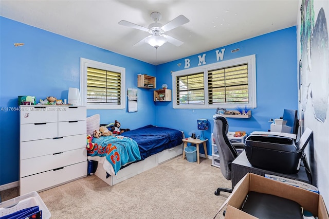 carpeted bedroom featuring baseboards and a ceiling fan