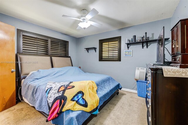 bedroom with baseboards, light colored carpet, and a ceiling fan