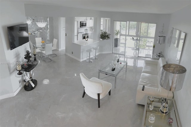 3836 Via Poinciana Unit 604, Lake Worth, FL 33467 - living room with baseboards and a chandelier