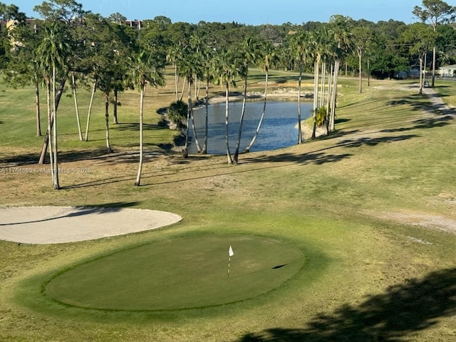 view of home's community with a water view and golf course view