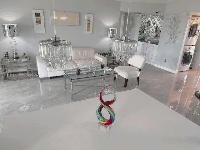 3836 Via Poinciana Unit 604, Lake Worth, FL 33467 - living room with stacked washer and clothes dryer and marble tiled flooring