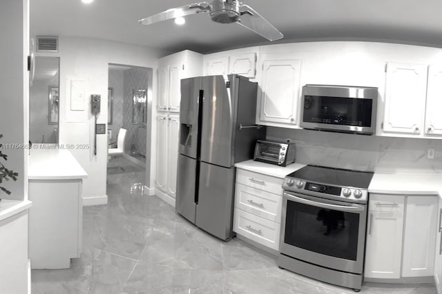 3836 Via Poinciana Unit 604, Lake Worth, FL 33467 - kitchen featuring appliances with stainless steel finishes, ceiling fan, white cabinetry, light marble finish flooring, and light countertops