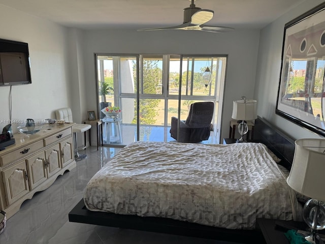 bedroom featuring ceiling fan, marble finish floor, and multiple windows