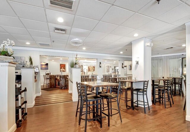 dining area featuring baseboards, visible vents, and wood finished floors
