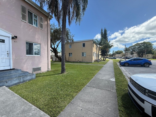 417 NW 84th St Unit 417, Miami, FL 33150 - view of home's exterior featuring stucco siding and a yard