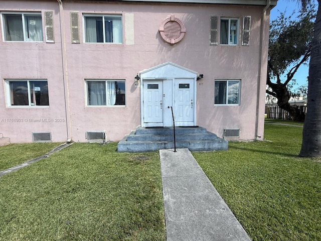 417 NW 84th St Unit 417, Miami, FL 33150 - view of front facade with crawl space, stucco siding, and a front yard