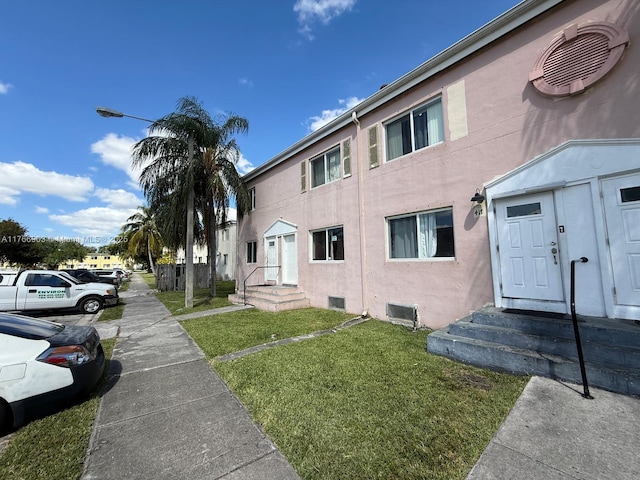 417 NW 84th St Unit 417, Miami, FL 33150 - view of home's exterior with stucco siding and a yard