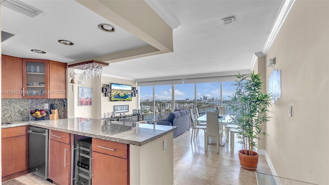 kitchen featuring backsplash, crown molding, wine cooler, brown cabinets, and a peninsula