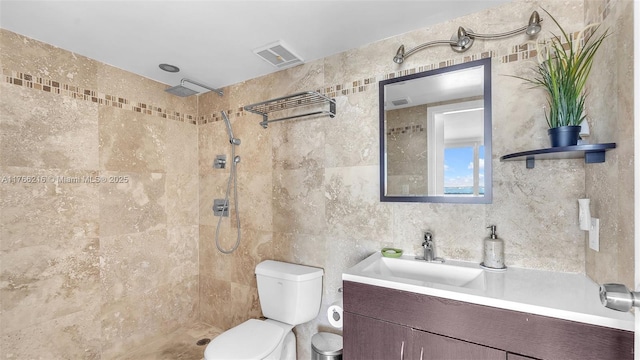 7601 E Treasure Dr Unit 1518, North Bay Village, FL 33141 - bathroom with tiled shower, toilet, tile walls, and vanity