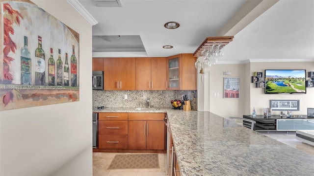 7601 E Treasure Dr Unit 1518, North Bay Village, FL 33141 - kitchen with a tray ceiling, a sink, stainless steel microwave, light stone counters, and crown molding