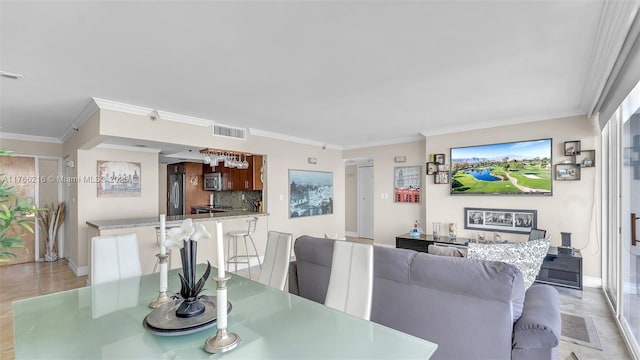 dining area with visible vents, baseboards, and ornamental molding