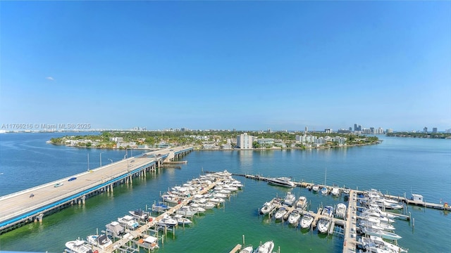 view of dock with a water view and a view of city
