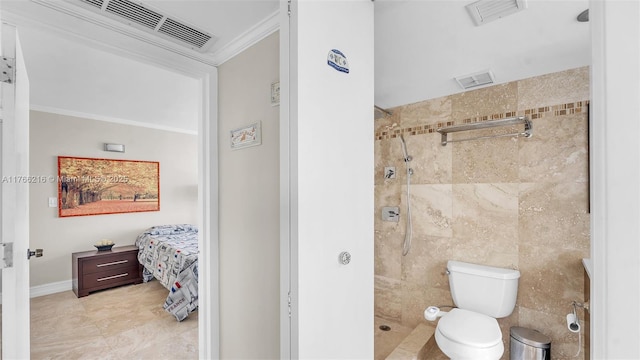 bathroom with vanity, visible vents, a tile shower, tile walls, and toilet