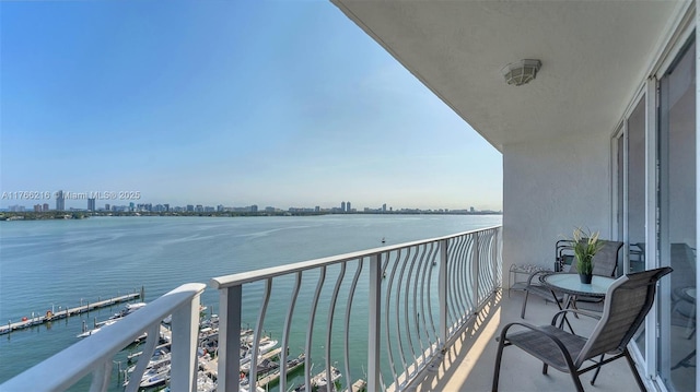 balcony featuring a view of city and a water view
