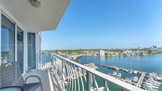 balcony featuring a city view and a water view