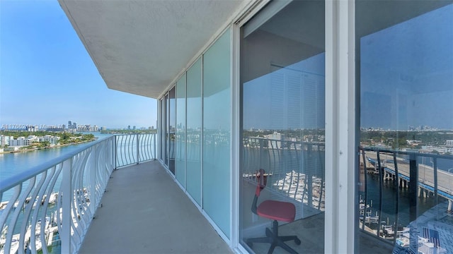 balcony with a water view and a city view