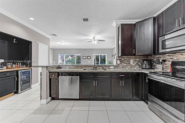 772 NW 132nd Ave, Plantation, FL 33325 - kitchen with crown molding, ceiling fan, beverage cooler, stainless steel appliances, and a sink