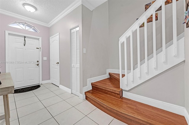 772 NW 132nd Ave, Plantation, FL 33325 - foyer entrance with a textured ceiling, light tile patterned flooring, crown molding, baseboards, and stairs