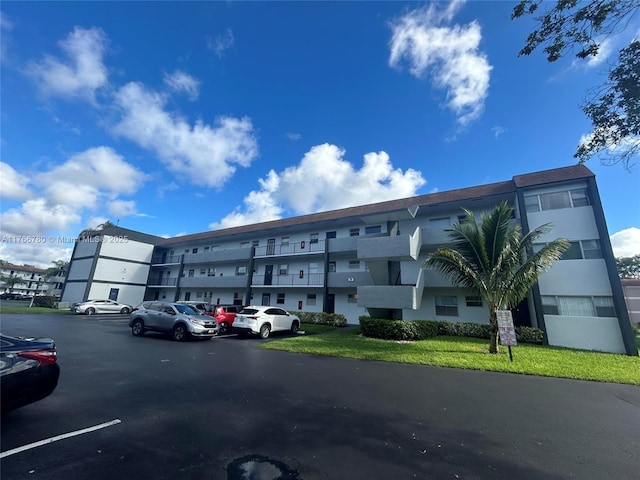 view of property featuring uncovered parking