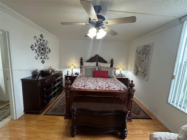 bedroom with light wood finished floors, a textured ceiling, and ornamental molding