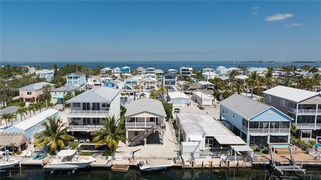 birds eye view of property with a residential view and a water view