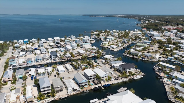 drone / aerial view with a residential view and a water view