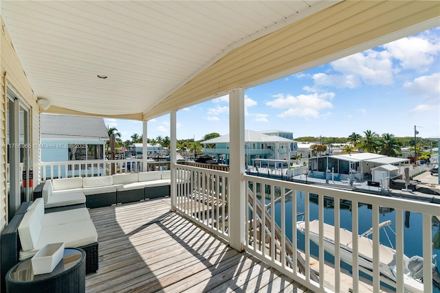 deck featuring a water view and an outdoor hangout area