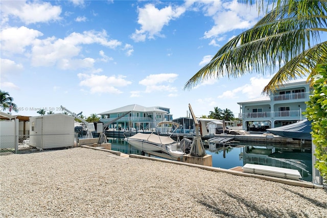 view of dock featuring a water view and fence