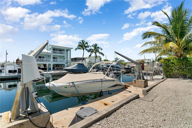 view of dock with boat lift and a water view