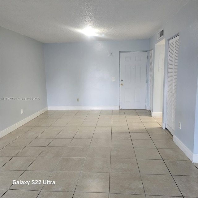 8200 SW 210th St Unit 111, Cutler Bay, FL 33189 - empty room featuring visible vents, baseboards, light tile patterned flooring, and a textured ceiling