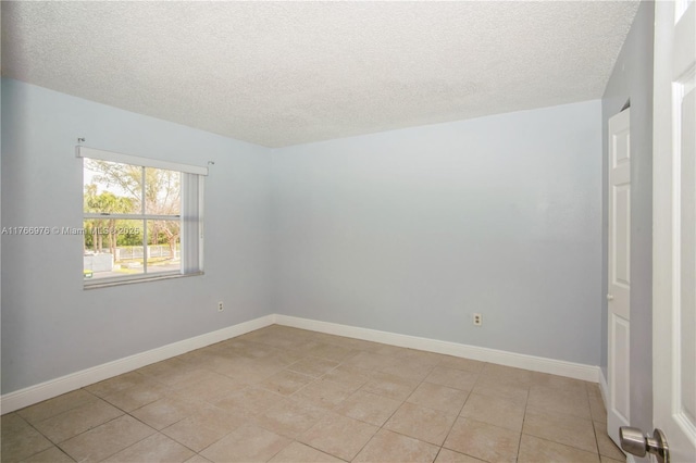 8200 SW 210th St Unit 111, Cutler Bay, FL 33189 - empty room with a textured ceiling, light tile patterned floors, and baseboards