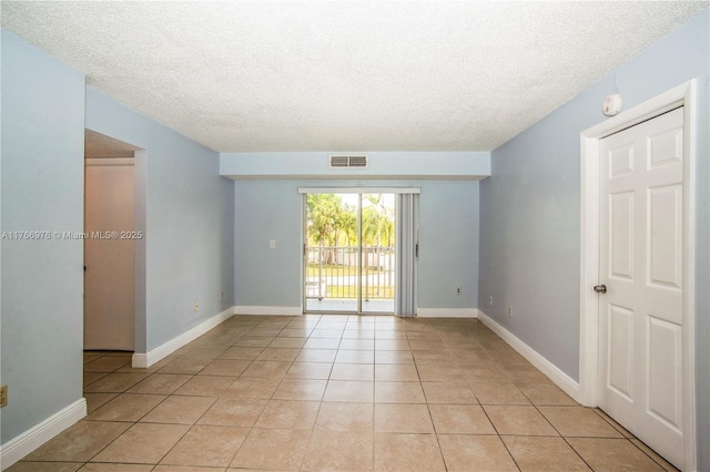 8200 SW 210th St Unit 111, Cutler Bay, FL 33189 - unfurnished room featuring light tile patterned floors, visible vents, a textured ceiling, and baseboards