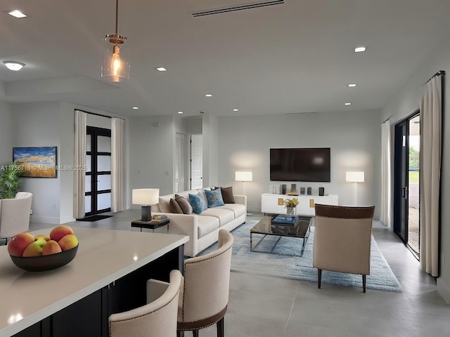 living room featuring recessed lighting and visible vents