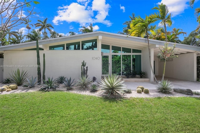 1040 NE 85th St, Miami, FL 33138 - rear view of property with a yard and an attached carport