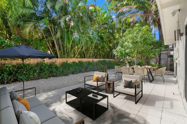 1040 NE 85th St, Miami, FL 33138 - view of patio / terrace featuring an outdoor living space, outdoor dining space, and a fenced backyard