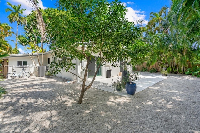 1040 NE 85th St, Miami, FL 33138 - view of front of property with stucco siding, cooling unit, and a patio